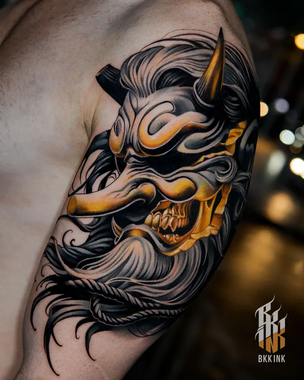 Gold and black hannya mask shoulder tattoo Bangkok by Vay