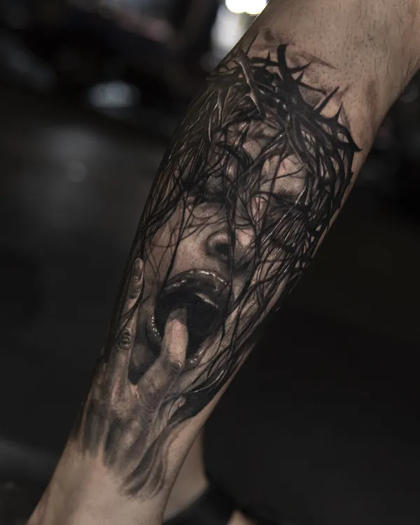 Screaming face in thorns forearm tattoo Bangkok by Zia