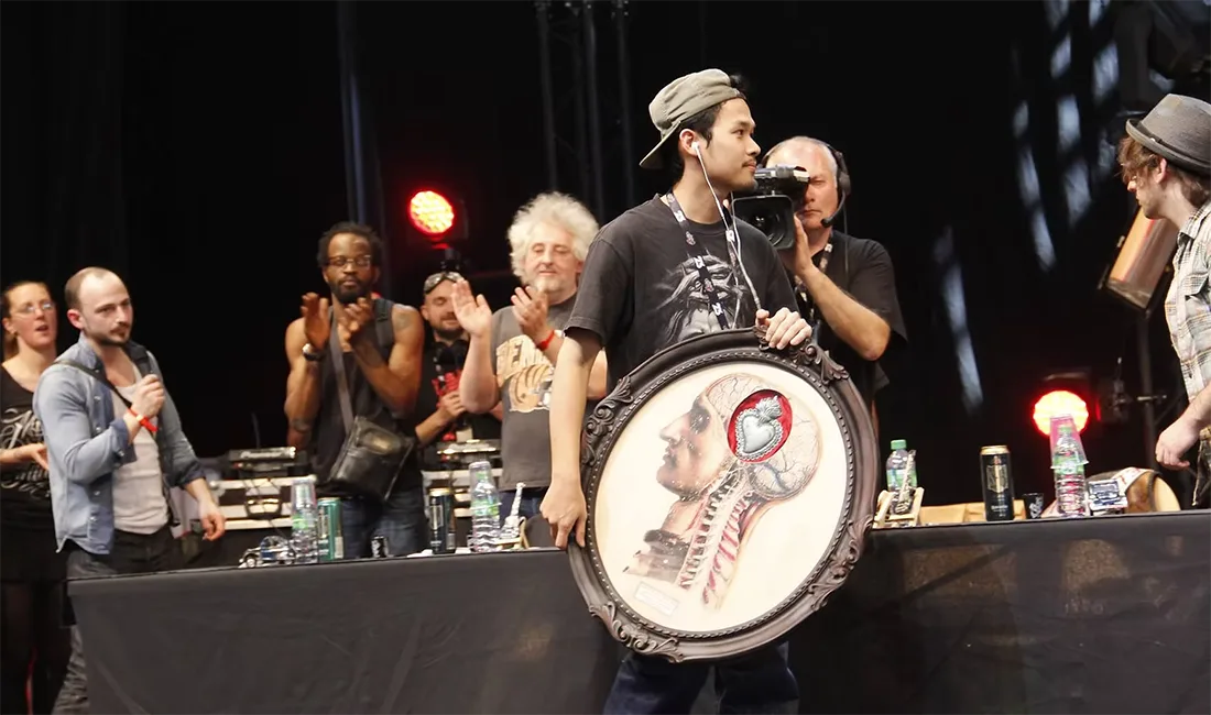 Ball BKK on stage at the Mondial du Tatouage with his framed Best of Full Back winning artwork