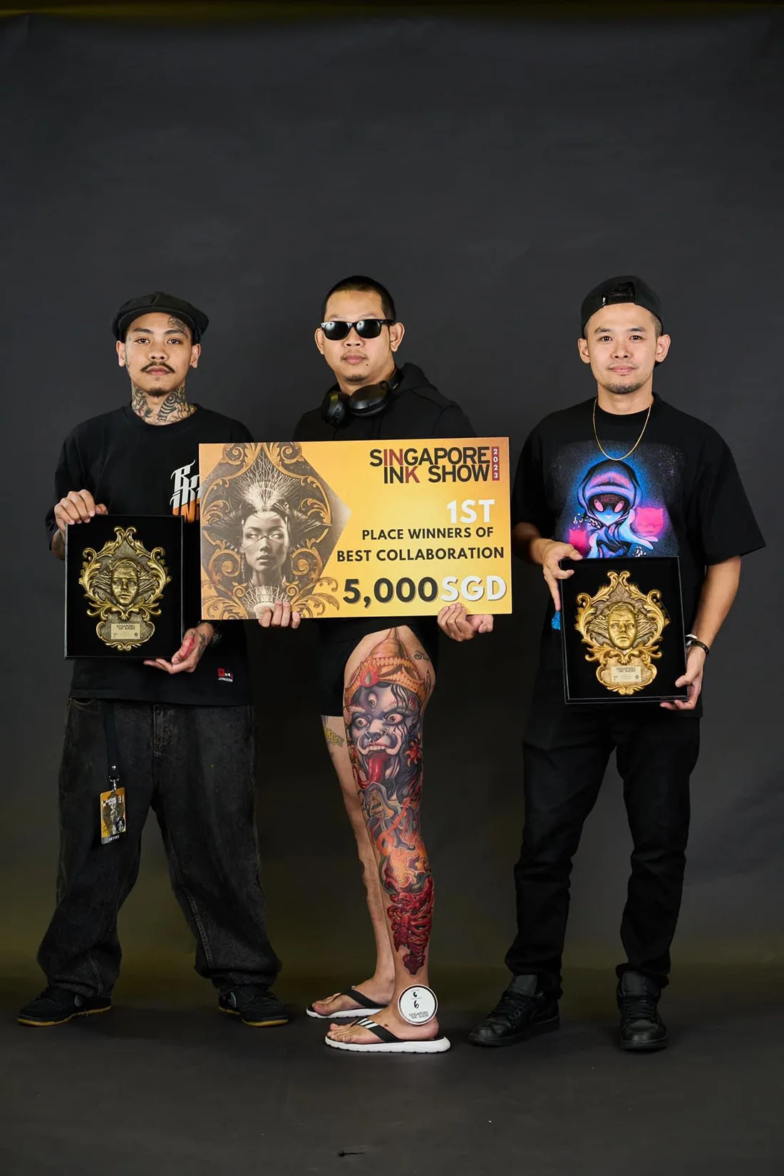 Three BKK INK artists with 1st place Best Collaboration trophies at the Singapore Ink Show