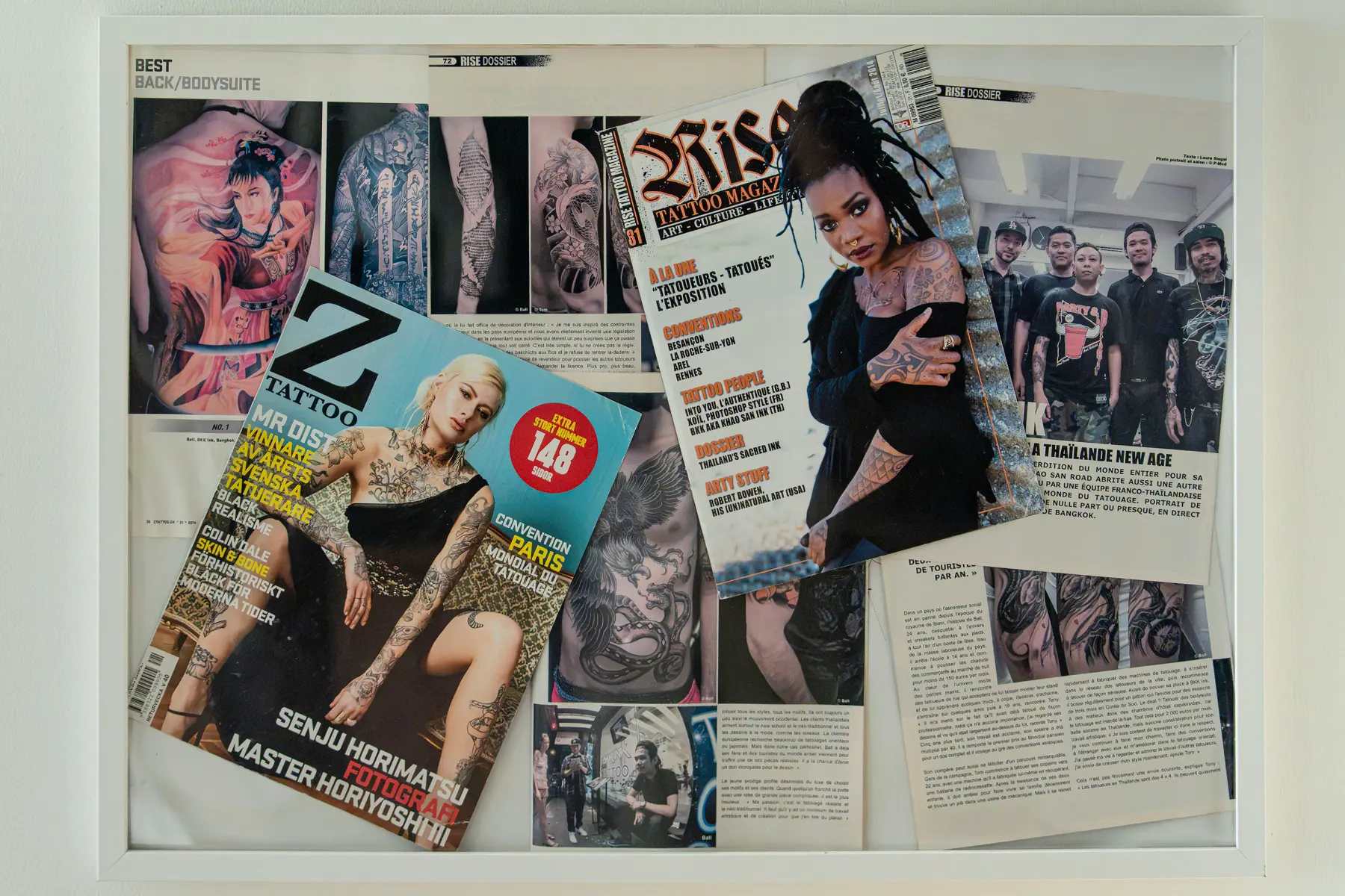 Framed pages from RISE Tattoo Magazine issue 31 and Z Tattoo issue 21, 2014, at our Bangkok studio