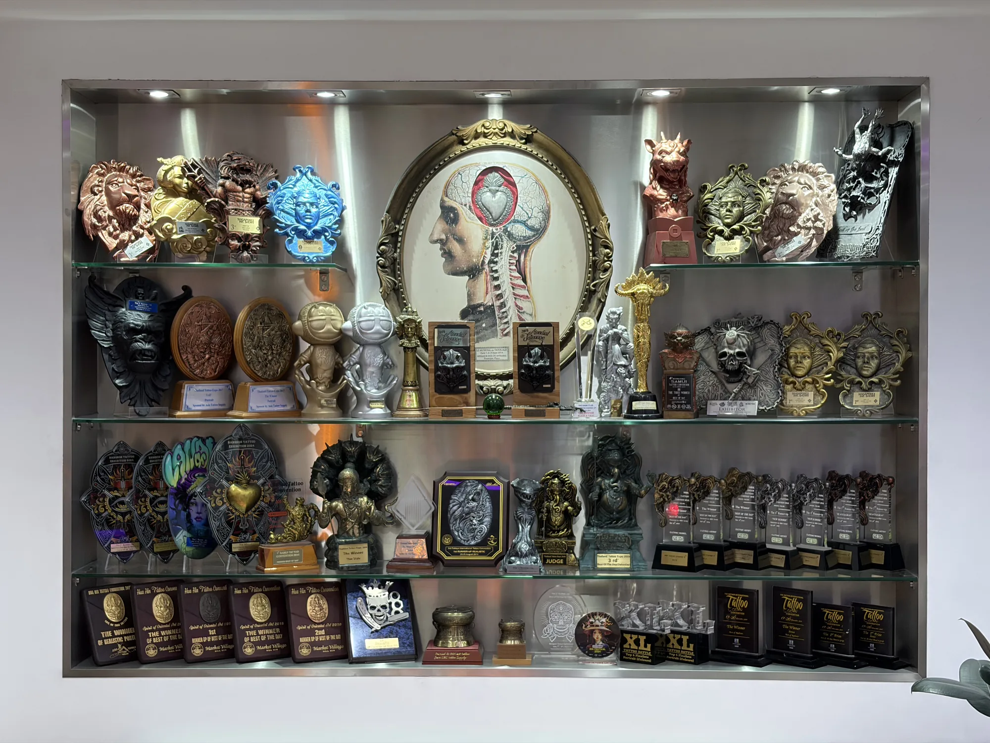 The trophy cabinet at BKK INK in Bangkok, holding the studio 56 tattoo convention awards won since 2010